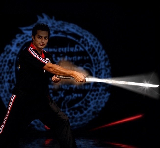 Mah Ghasemi in a martial arts stance holding a sword